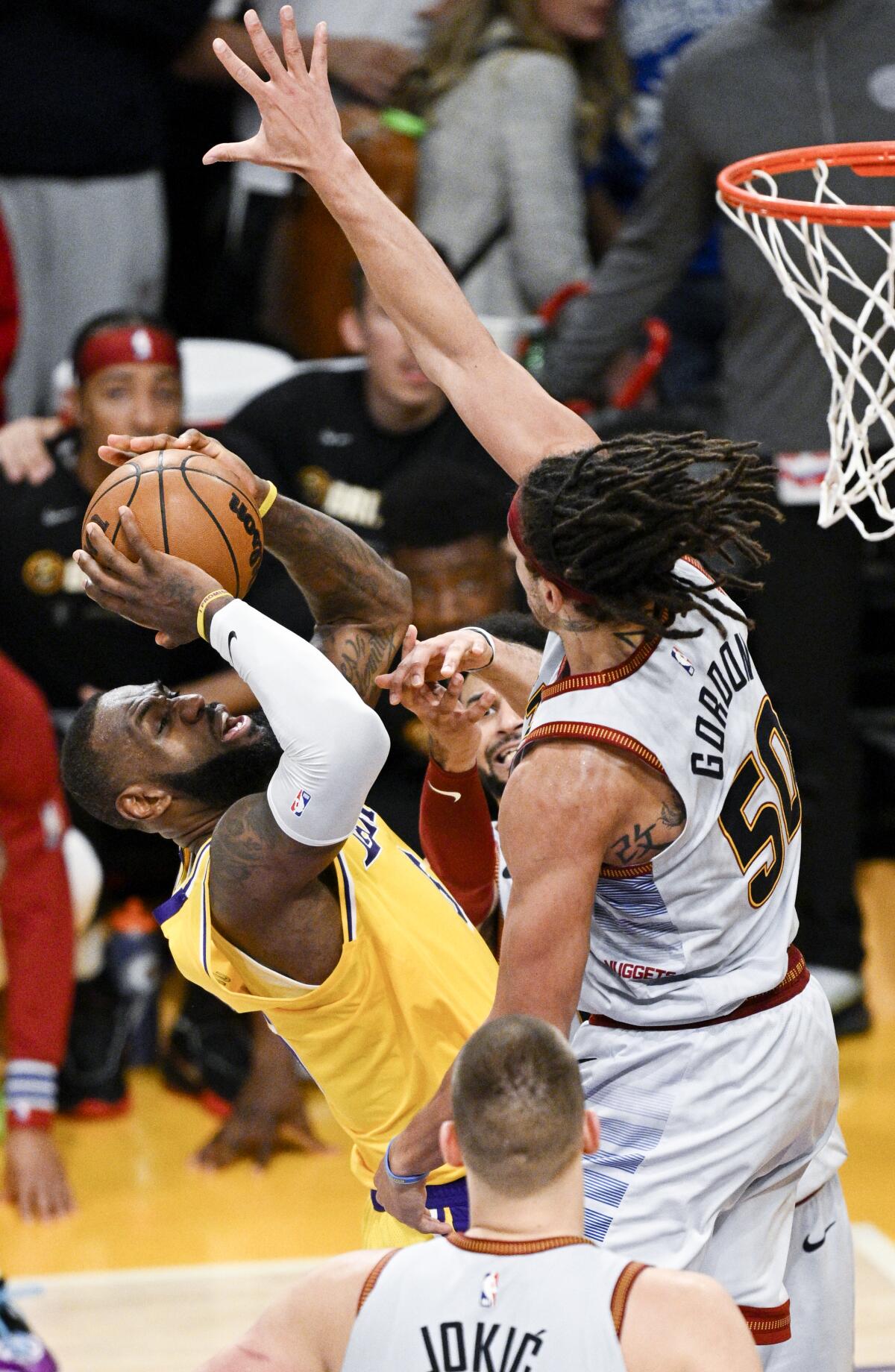 Lakers forward LeBron James, left, attempts a shot that was blocked by Nuggets forward Aaron Gordon to end Game 4.