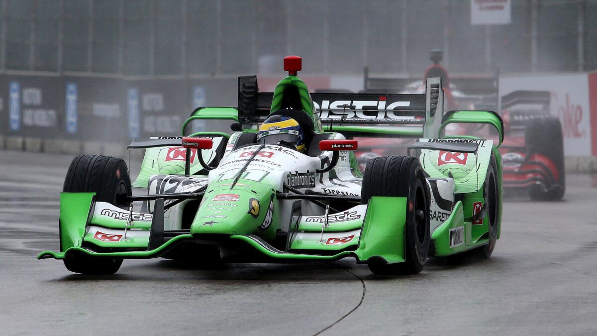 IindyCar driver Sebastien Bourdais leads the pack Sunday in the rain during the Detroit Grand Prix's second race.
