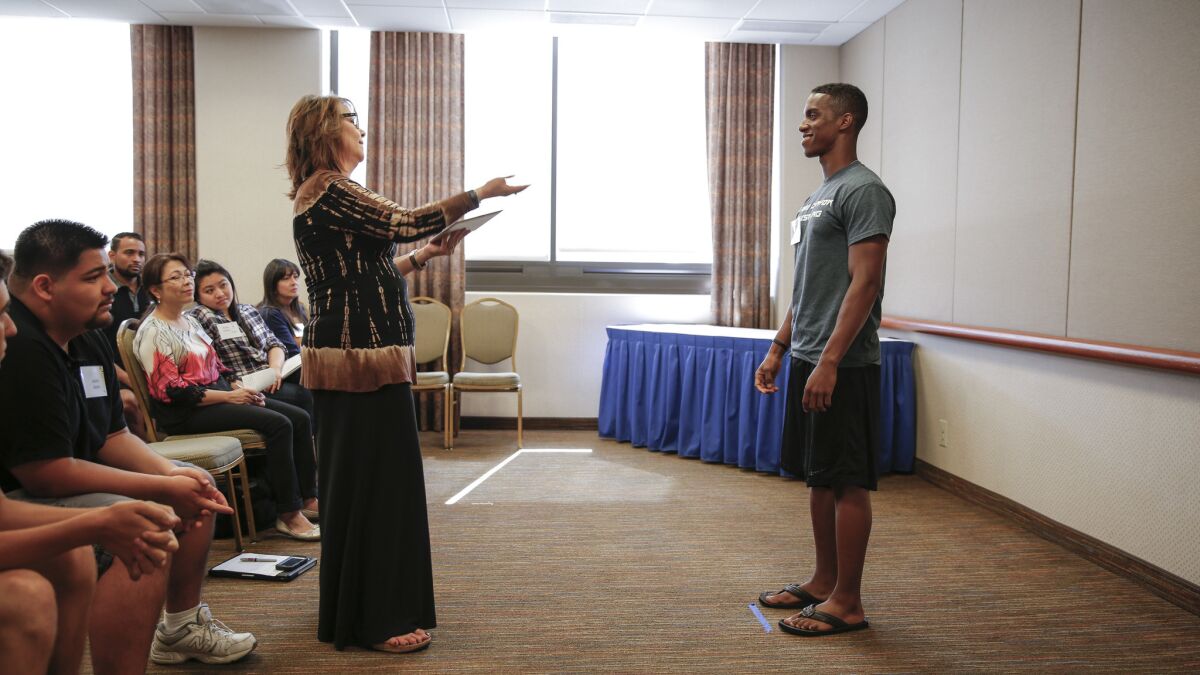 JoAnn Smolen, left, a talent manager, instructs 20-year-old Alex Stovall at a seminar by Actors, Models & Talent for Christ.