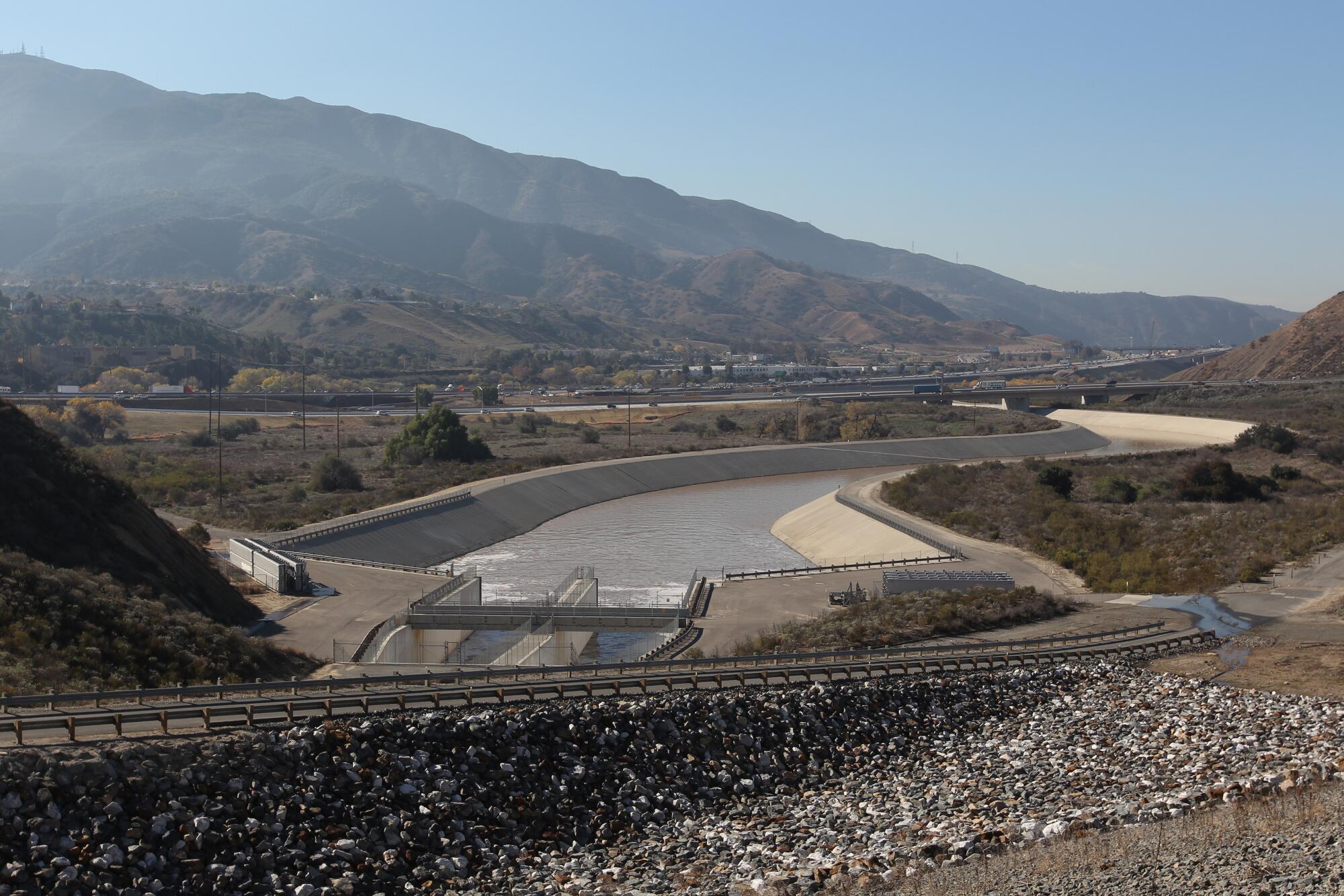 Storm water flows down the Santa Ana River channel from Prado Dam 