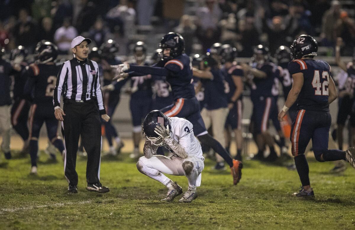 Newport Harbor's Johnny Chaix holds his head following Cypress' go-ahead field goal in the final seconds on Friday.