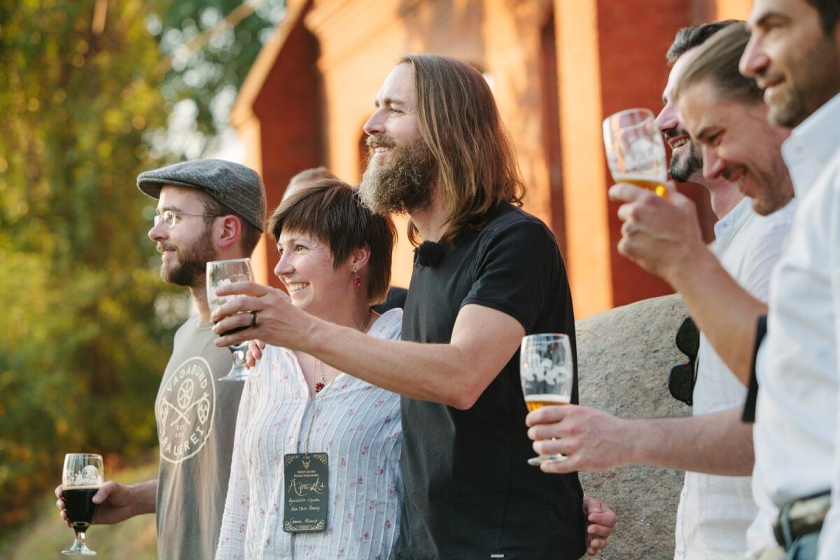 In this 2014 photo, provided by Stone Brewing Co., Stone Brewing Co. CEO and co-founder Greg Koch (center) toasts the crowd.