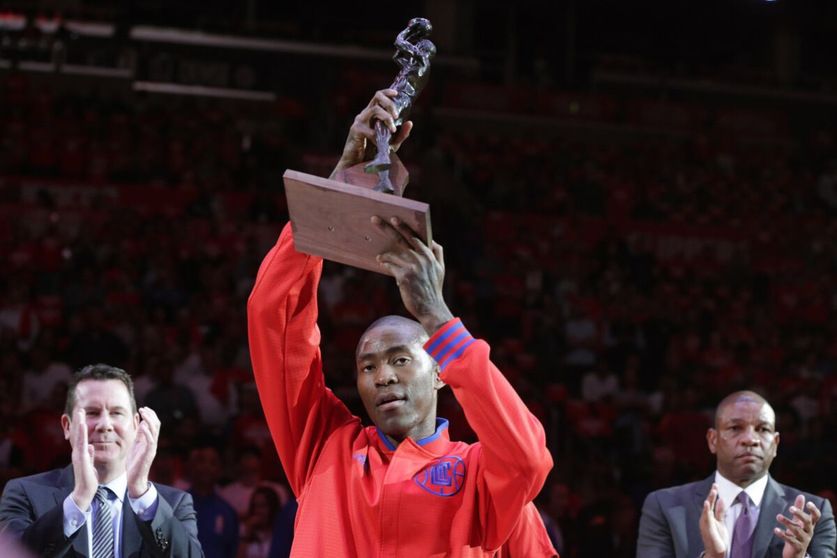 Jamal Crawford holds aloft the trophy he won as the NBA sixth man of the year during a ceremony before a playoff game in April.It was his third such award overall, his second as a member of the Clippers.