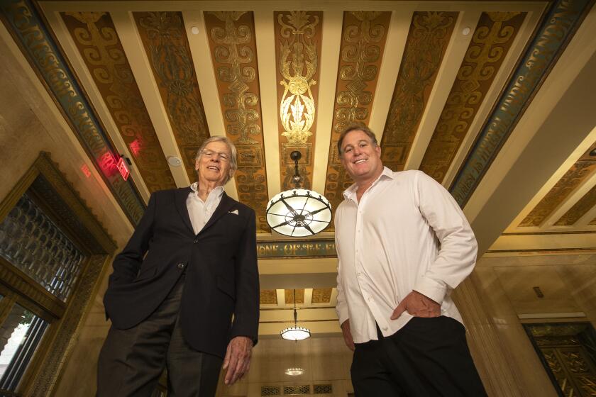 LOS ANGELES, CA-SEPTEMBER 5, 2019: Nelson Rising, left, Chairman of Rising Realty Partners, and his son Christopher Rising, Chief Executive Officer, stand inside the restored lobby of The Trust Building on Spring St. in downtown Los Angeles. The Title Insurance and Trust building was considered one of the finest on the ?Wall Street of the West? when it opened in 1928. Designed by noted Los Angeles architects John and Donald Parkinson, it is considered an outstanding example of Art Deco architecture. It fell into decline and then disuse after the title company left in 1977, but it has just been restored and will again be used as a high-end office building. (Mel Melcon/Los Angeles Times)