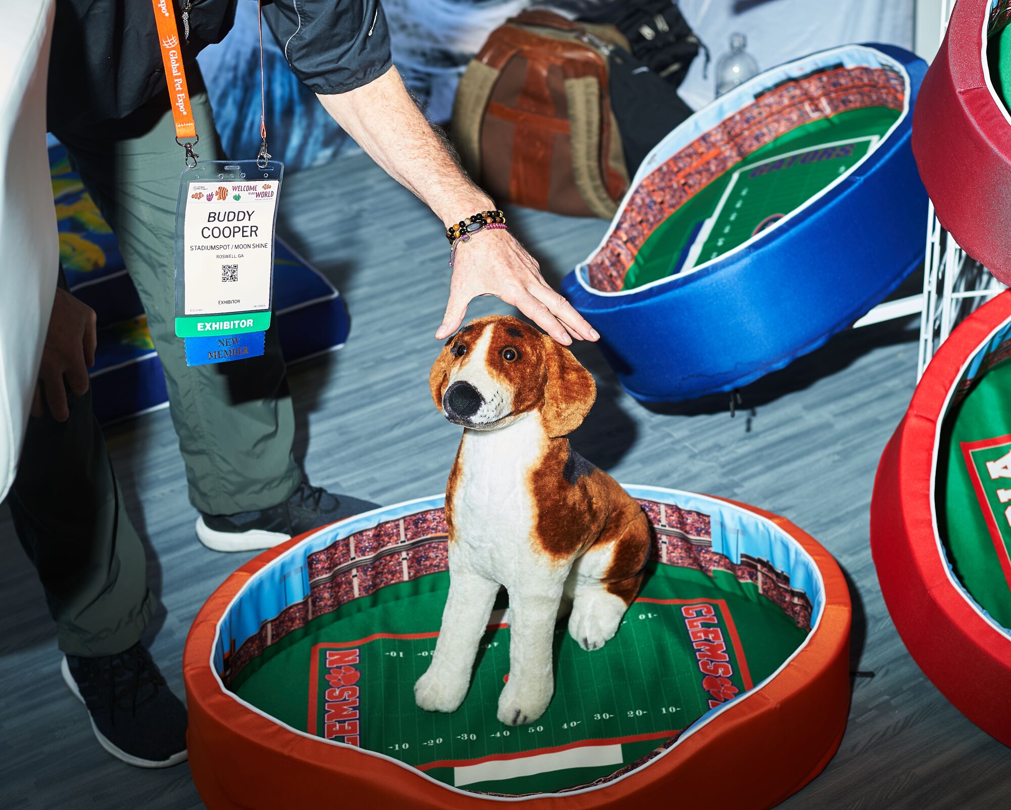 A stuffed animal is used to show off a football-themed pet bed.