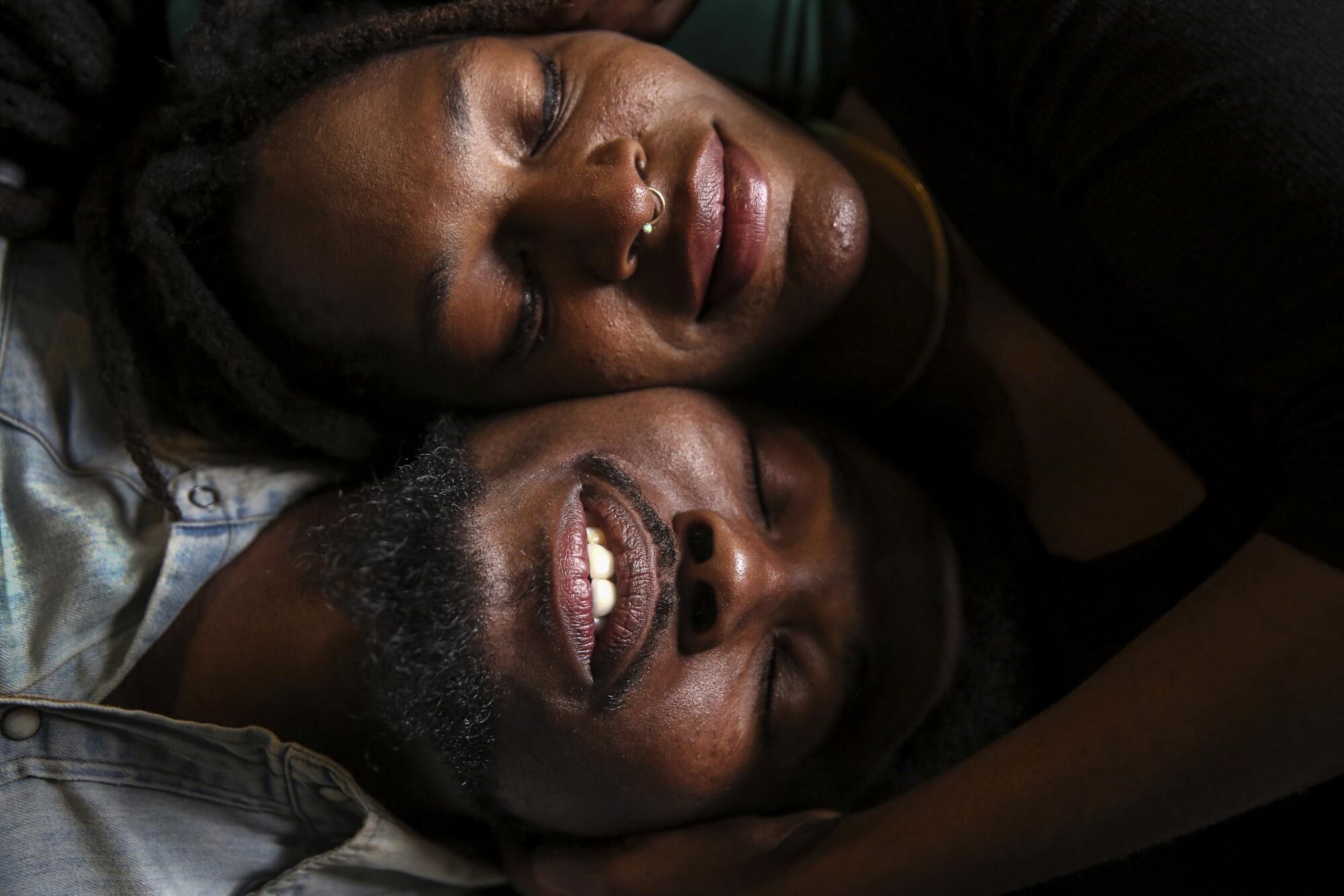 Tiffani and Lance Bryant pose with their cheeks pressed together.