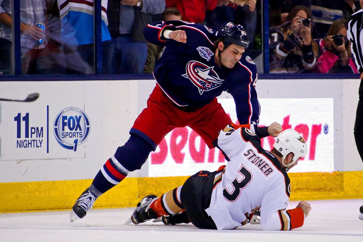 Blue Jackets forward Jared Boll throws a punch against Ducks defenseman Clayton Stoner during the Blue Jackets' 5-3 win.