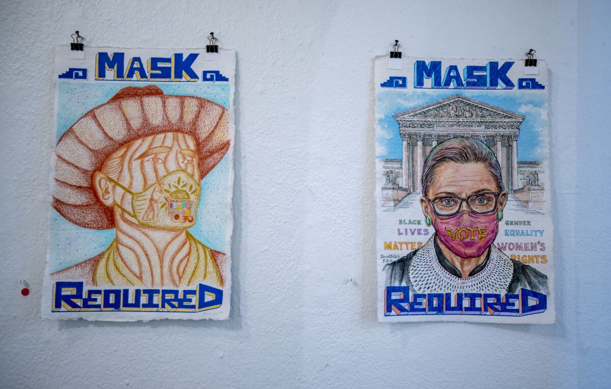 Watercolor posters at an art studio read "Mask Required."