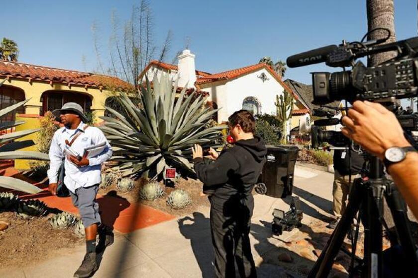 Fotógrafos y camarógrafos se colocan el lunes en las afueras de la casa de la madre de Meghan Markle en Los Ángeles. (Christina House / Los Angeles Times)