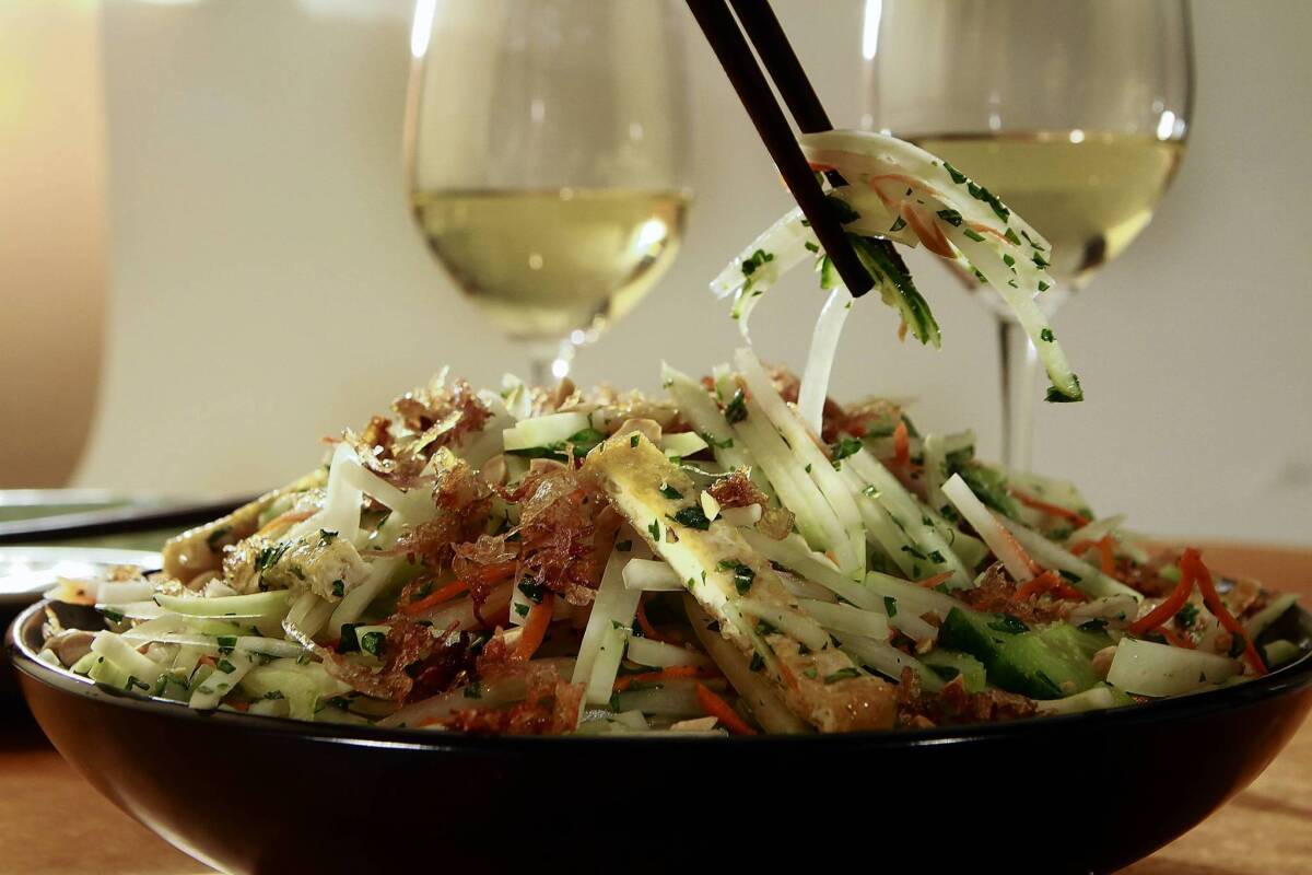 A green papaya salad would pair well with a sweeter white blend with a crisp minerality.