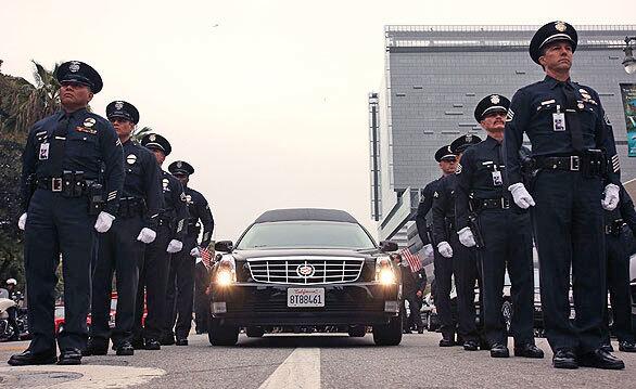 Los Angeles Police Department officers line up during the funeral procession for former LAPD Chief Daryl Gates. See full story