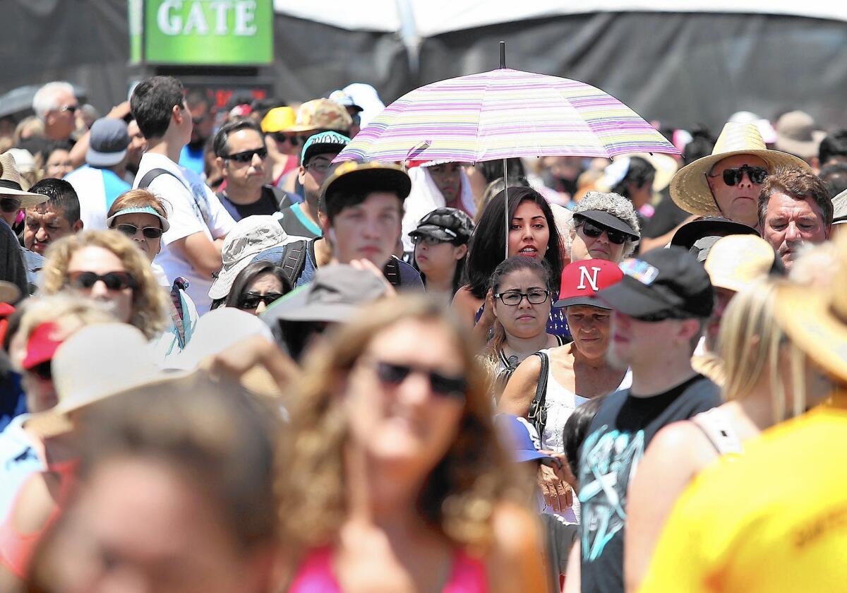 Guests crowd the green gate entrance as they patiently wait to enter the 2015 Orange County Fair on opening day on Friday. This year's theme is "One Big Party" and the fair's 125th anniversary.