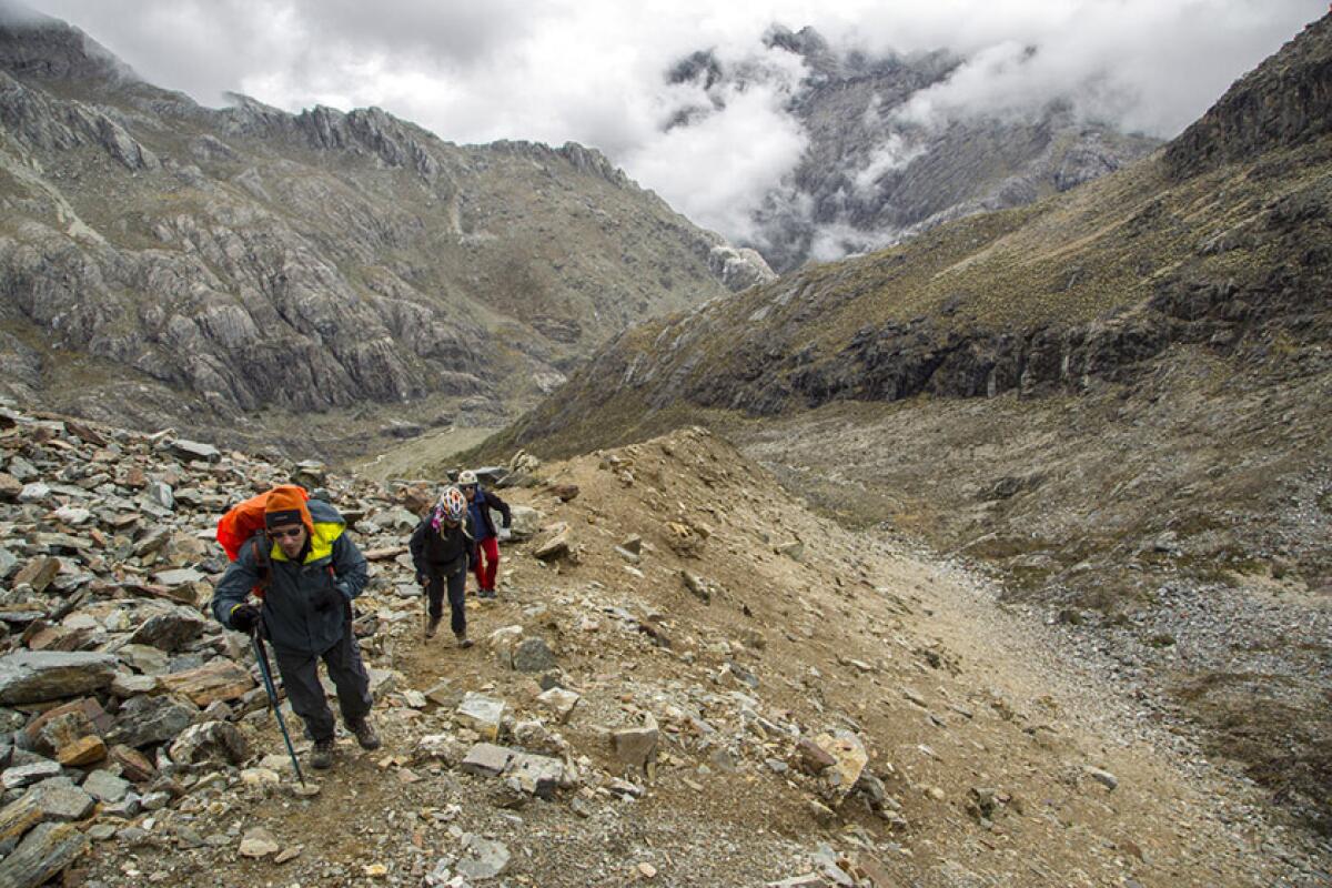 Scientists walk along a hilly path during an expedition to the Humbolt glacier in May. Their research tools and supplies are limited by Venezuela's collapse into poverty, but the scientists feel bound to document the impending disappearance of their nation's last glacier.