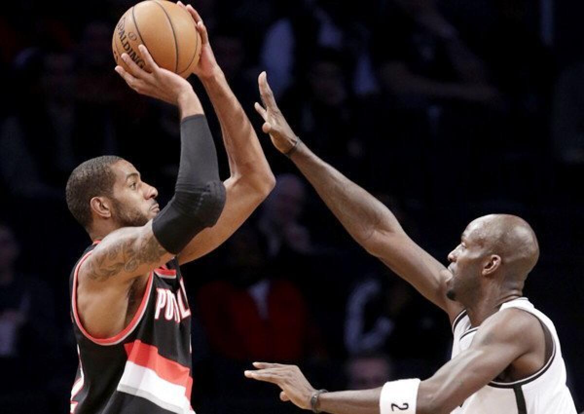 Trail Blazers power forward LaMarcus Aldridge elevates for a shot over Nets power forward Kevin Garnett during a game earlier this season.