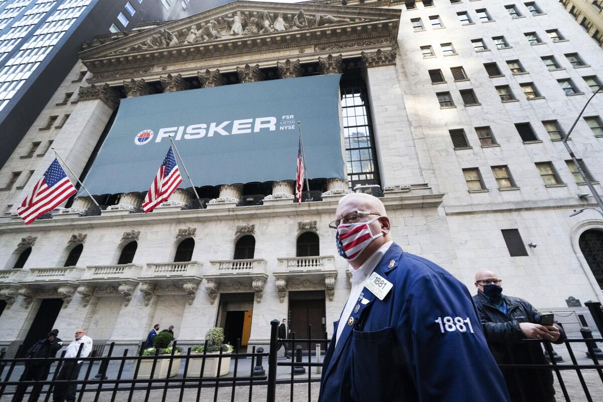 Stock trader Thomas Ferrigno arrives to work at the New York Stock Exchange on Monday.