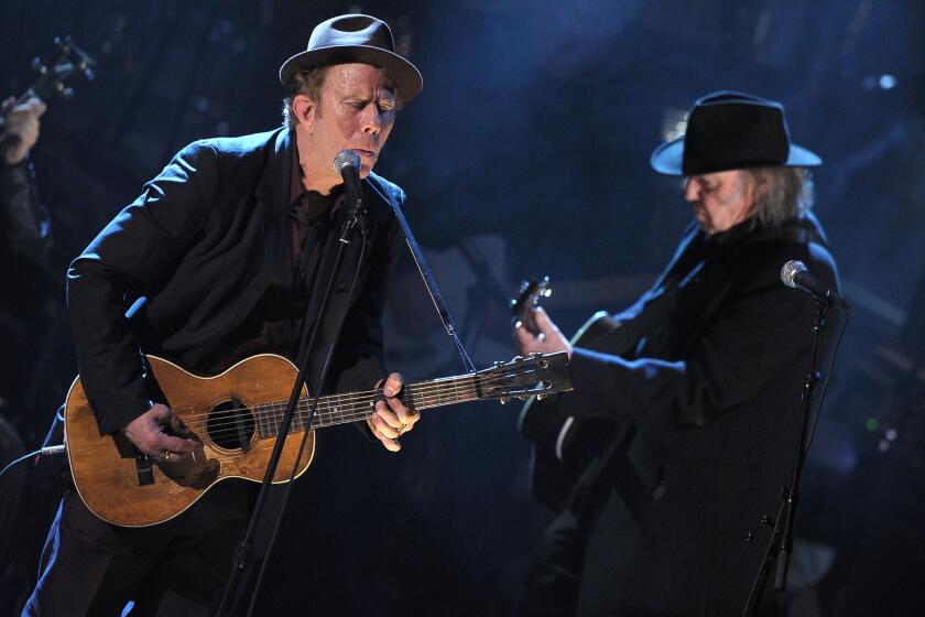 Tom Waits, left, was inducted in 2011 into the Rock and Roll Hall of Fame by Neil Young, who will perform the same duty for 2017 inductee Pearl Jam.