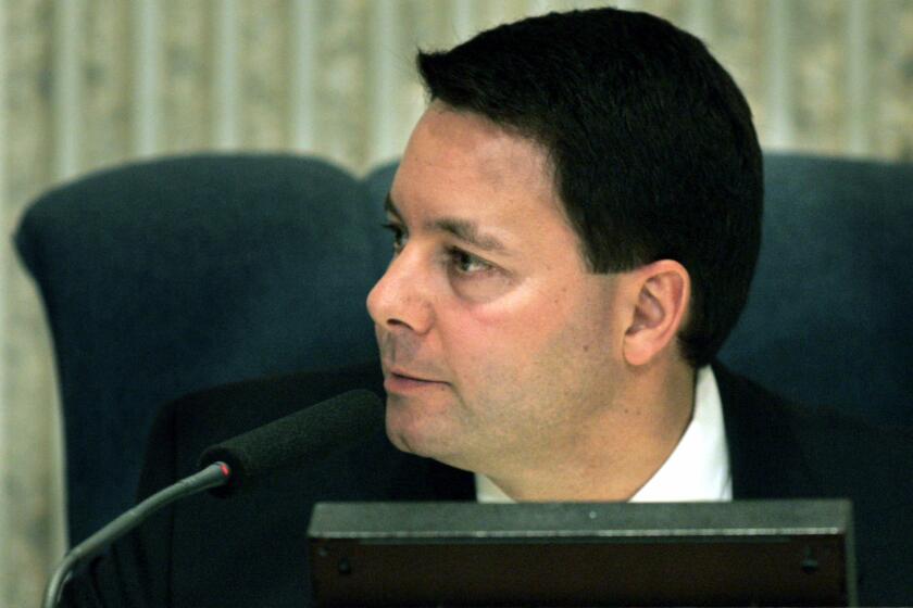 Costa Mesa City Councilman Allan Mansoor, shown during a 2005 meeting, says a website in his name was "hijacked" and repurposed to advertise pornography.