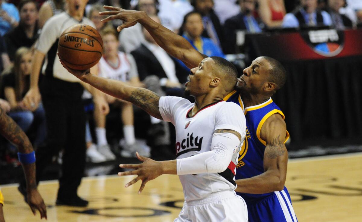 Trail Blazers guard Damian Lillard tries to score against Warriors forward Andre Iguodala during the second half Saturday night.