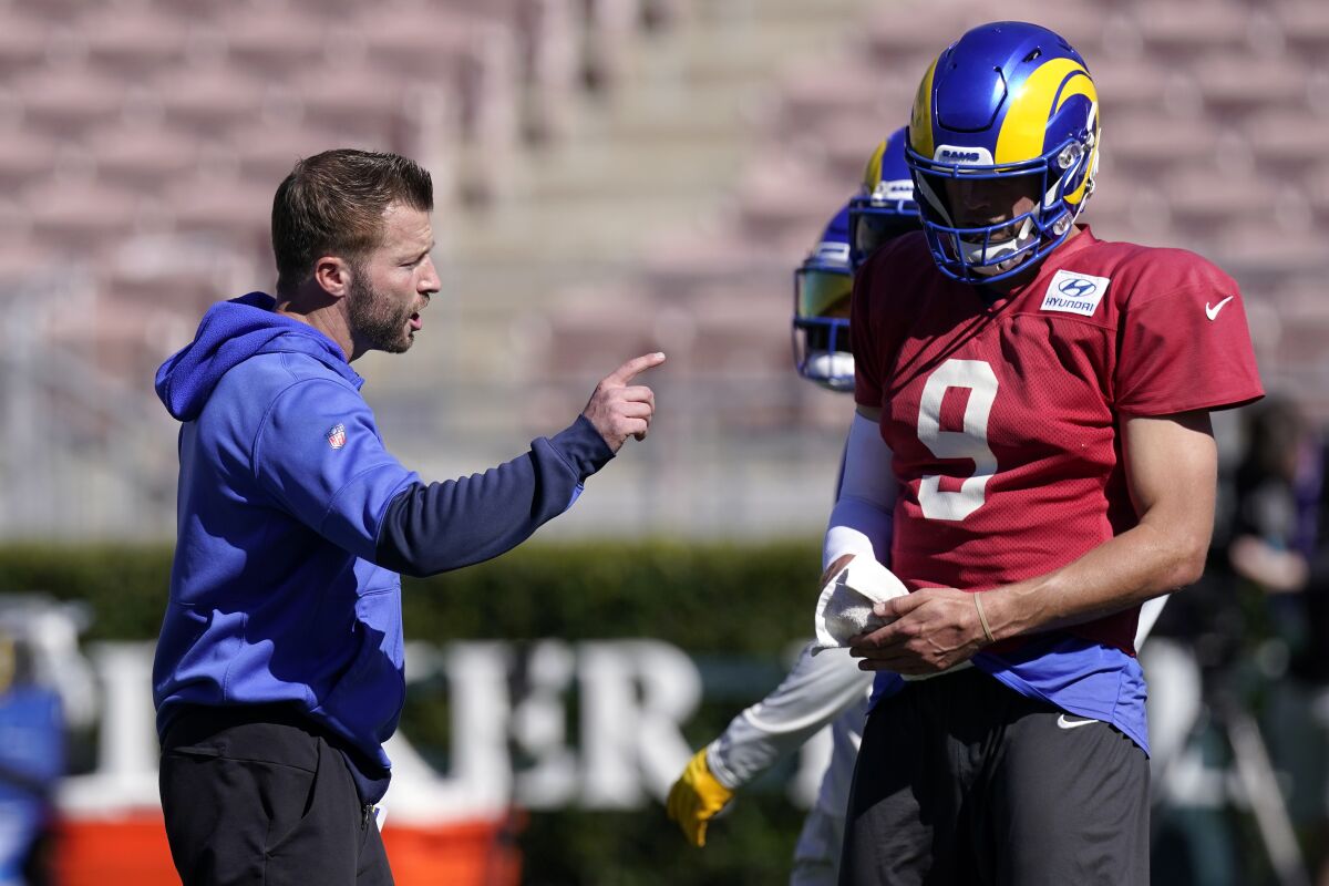 Los Angeles Rams head coach Sean McVay, left, talks to quarterback Matthew Stafford during practice for an NFL Super Bowl football game Thursday, Feb. 10, 2022, in Pasadena, Calif. The Rams are scheduled to play the Cincinnati Bengals in the Super Bowl on Sunday. (AP Photo/Mark J. Terrill)