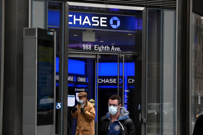 NEW YORK, NEW YORK - APRIL 29: People walk past a Chase bank during the coronavirus pandemic on April 29, 2020 in New York City. COVID-19 has spread to most countries around the world, claiming over 227,000 lives with infections of over 3.2 million people. (Photo by Rob Kim/Getty Images)