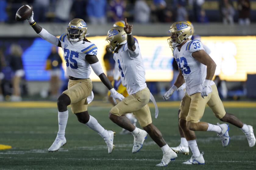 UCLA linebacker Carl Jones Jr. (35) celebrates after he recovered a California fumble to seal the Bruins' win Nov. 25, 2022.