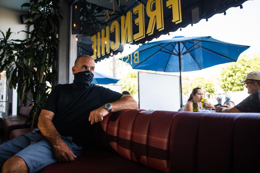 Little Frenchie owner, David Spatafore, poses inside his restaurant. San Diego restaurants may be able to serve customers indoors at a 25 percent max capacity after a noon conference with state officials.