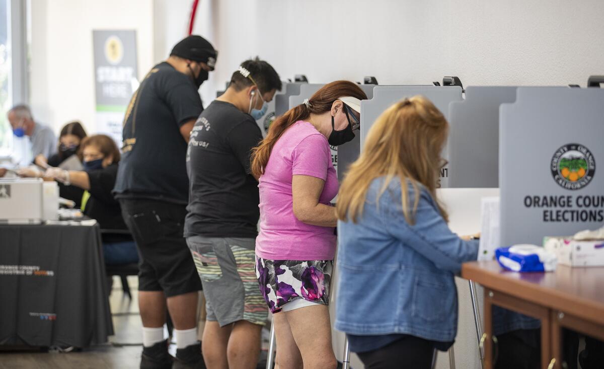 Voters cast their ballot at the Costa Mesa City Hall voting center in 2020.