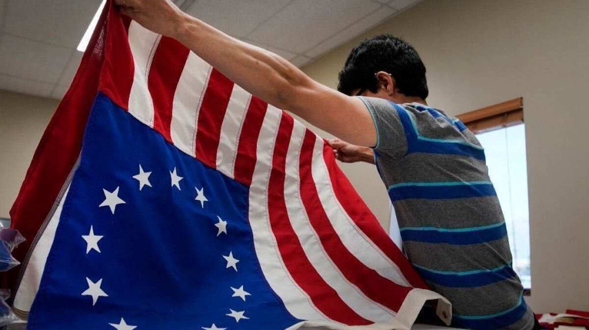 A worker folds a newly made Betsy Ross flag at a business in Salt Lake City, Utah, on July 5.