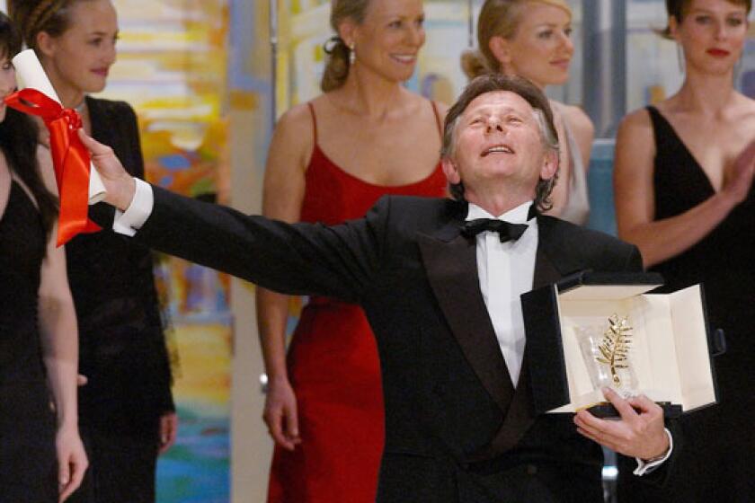 Roman Polanski celebrates after being awarded with the Golden Palm for his film 'The Pianist' during the closing ceremony of the 55th Cannes film festival on May 26, 2002.