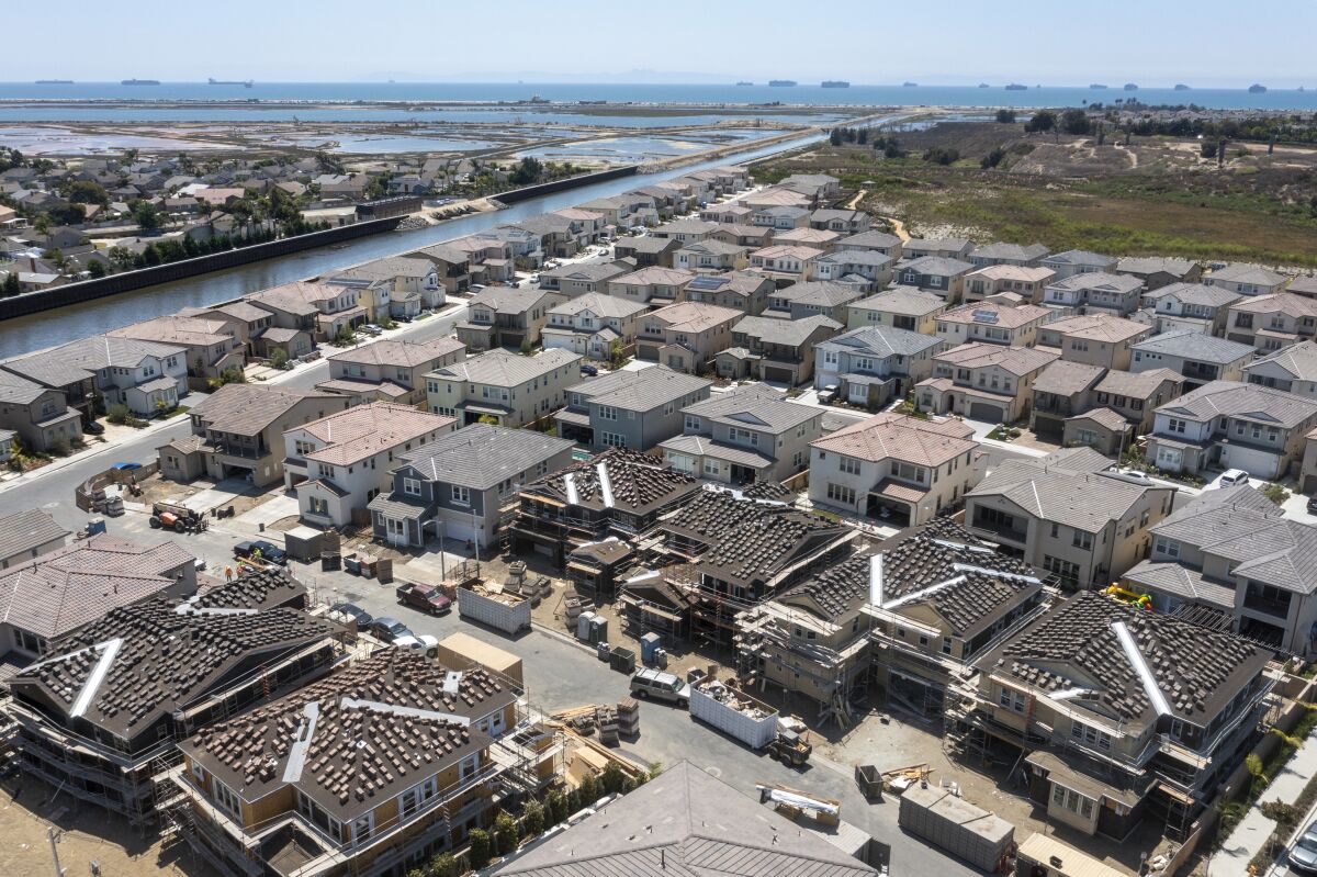 Huntington Beach, CA - August 09: An aerial view of workers constructing new homes at Parkside Estates in Huntington Beach.