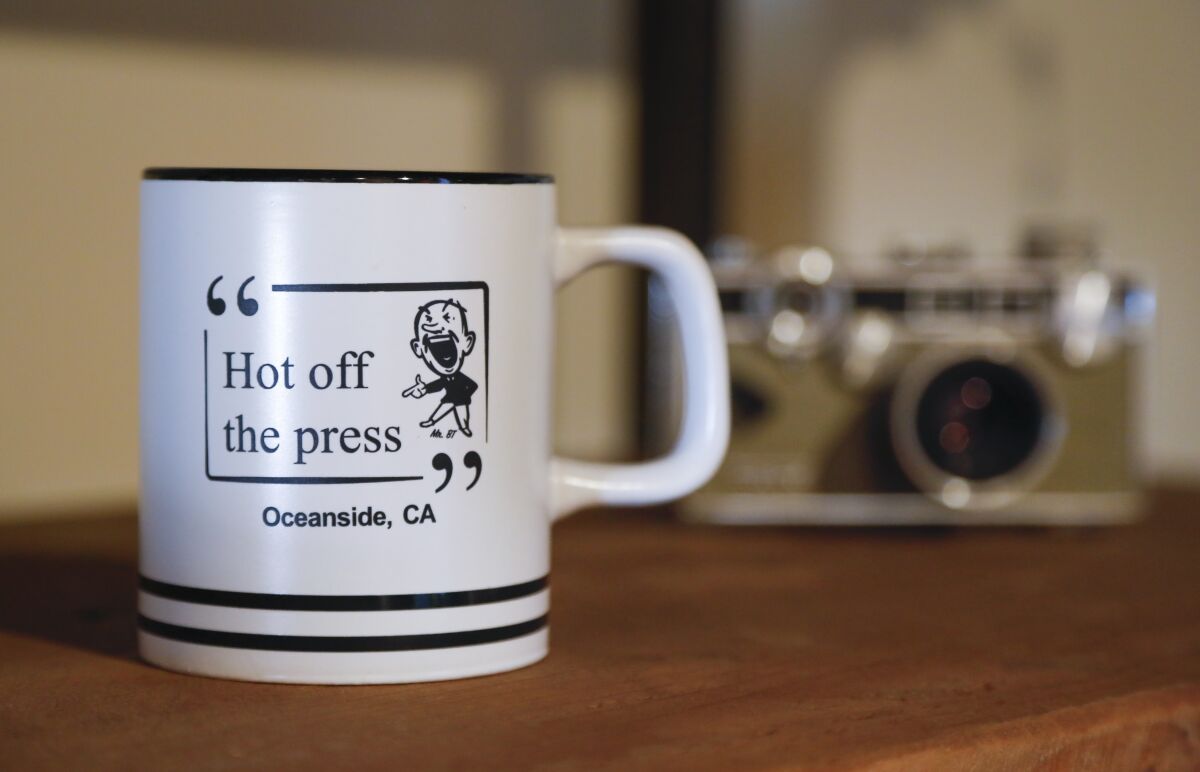 Newspaper-themed memorabilia including film cameras and a mug with the famous saying, "Hot off the Press" and the former Blade-Tribune's "Mr. B.T." cartoon mascot is on display in the original Blade-Tribune and News building on Seagate Drive in Oceanside. Built in 1936 and designed by famed architect Irving Gill, it is now home to the the new Italian restaurant Blade 1936, which has a newspaper theme that celebrates newspapers, and especially the ones that once called the building home. Photographed September 24, 2019, in Oceanside, California.