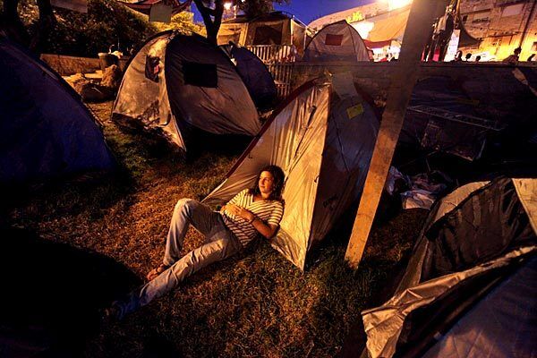 An Israeli girl rests in a tent city set up in a small central Jerusalem park. Protests against the high cost of housing began July 14, when Israelis began setting up encampments in at least 15 towns and cities.