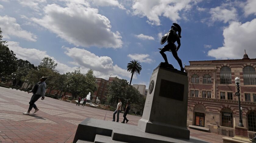 The statue of Tommy Trojan looks up at cloudy skies from his pedestal in the middle of the USC campus on Saturday.