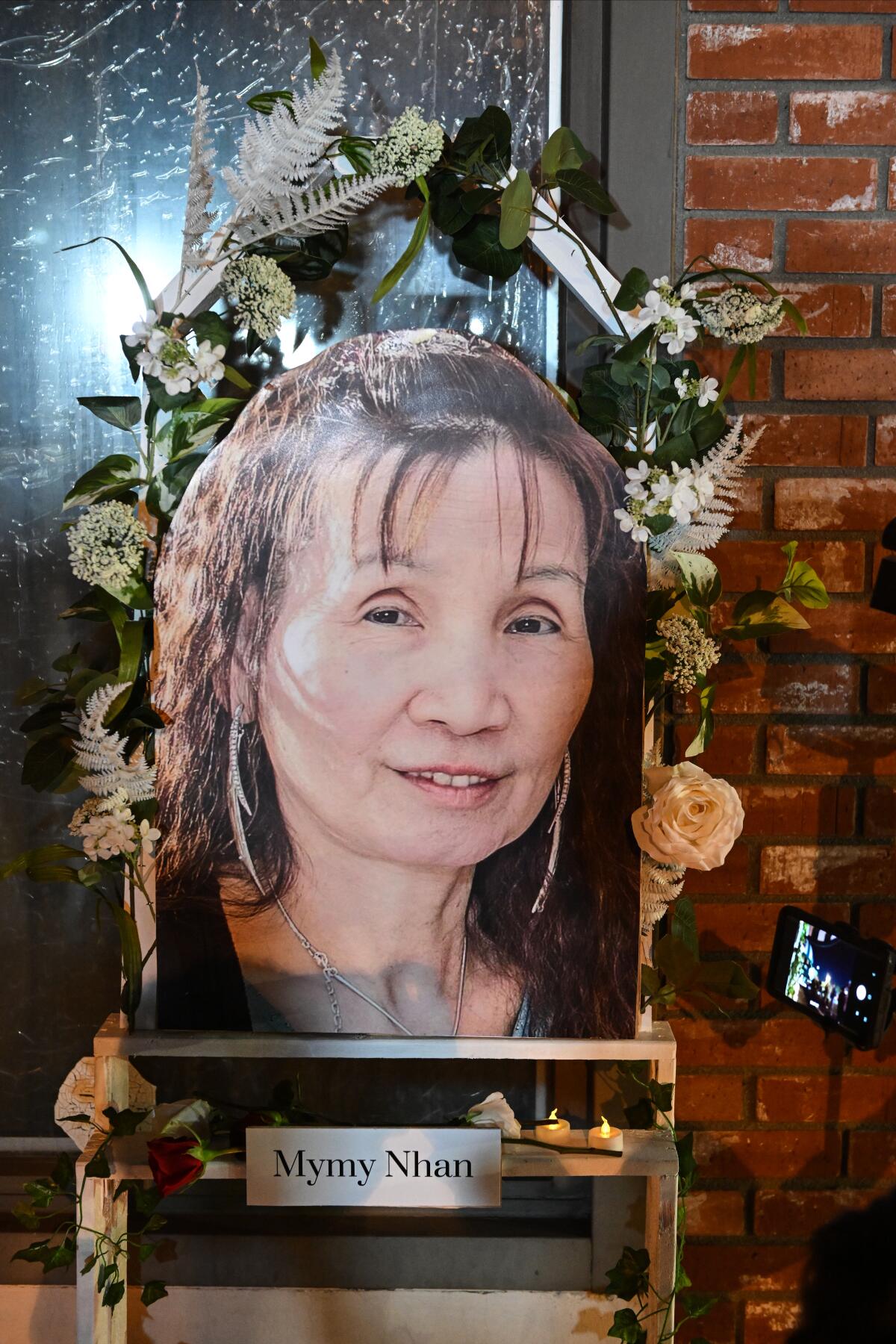A portrait of Mymy Nhan sits on display in front of the dance studio.