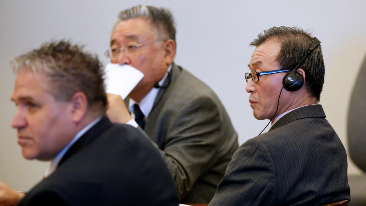 Beong Kwun Cho, far right, listens to testimony through an interpreter while next to his his attorney, Robert Kohler, far left, during his trial.