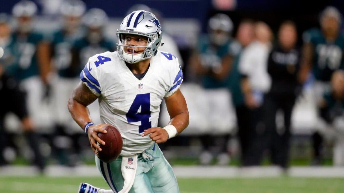 Cowboys quarterback Dak Prescott scrambles out of the pocket during a game against the Eagles on Oct. 30.