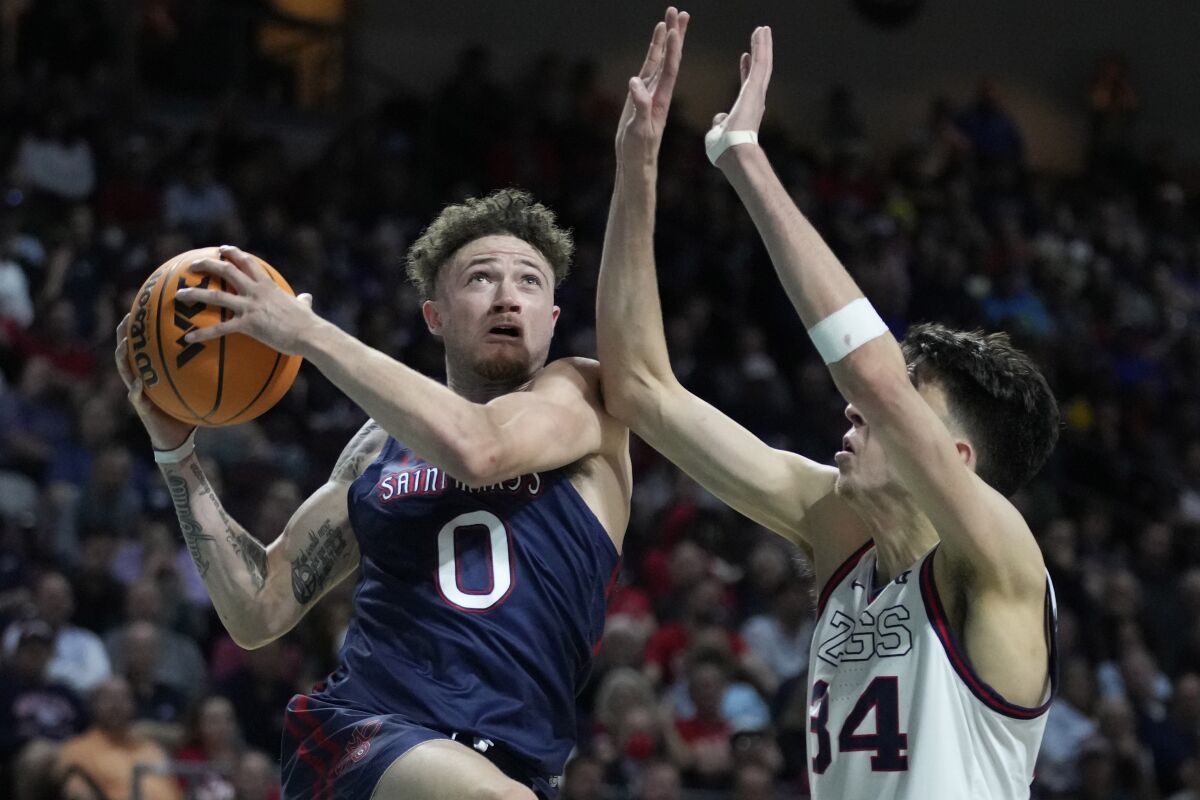 Saint Mary's Logan Johnson (0) shoots against Gonzaga's Chet Holmgren (34) during the second half of an NCAA college basketball championship game at the West Coast Conference tournament Tuesday, March 8, 2022, in Las Vegas. (AP Photo/John Locher)