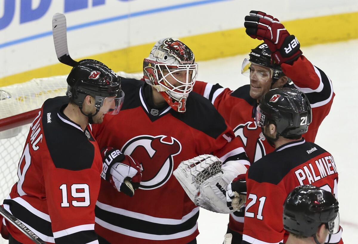 Devils goalie Keith Kinkaid is congratulated by teammates Travis Zajac (19), Andy Greene (6) and ng Kyle Palmieri (21) after a 1-0 victory over the Kings.