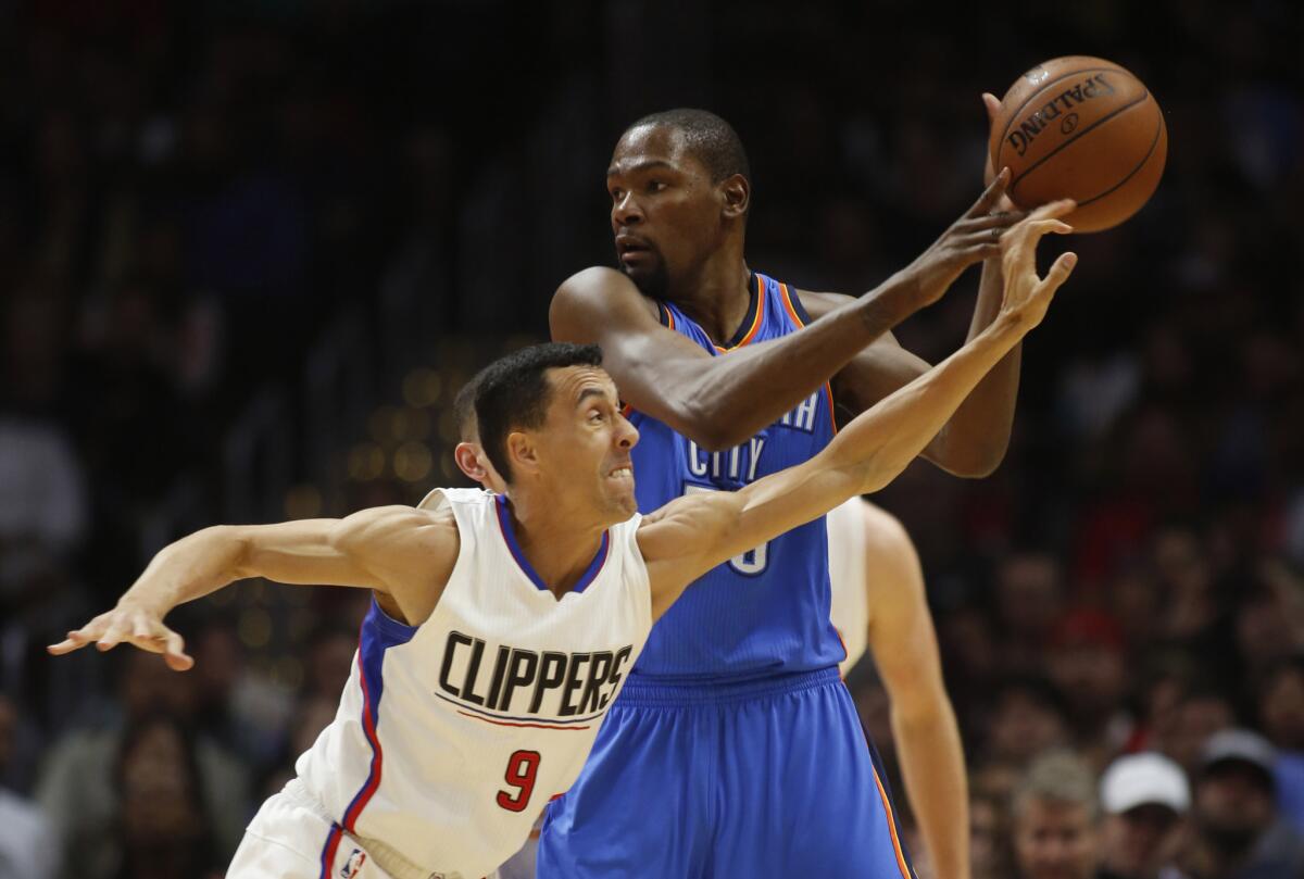 Clippers guard Pablo Prigioni tries to knock the ball away from Thunder forward Kevin During during the first half of a game on March 2.