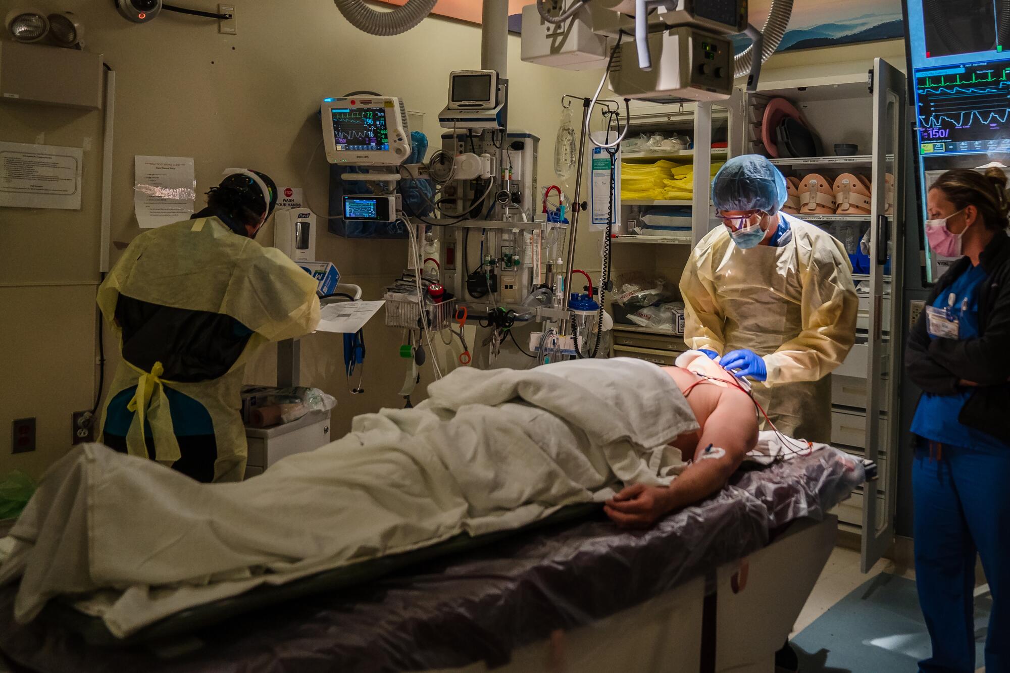 Healthcare workers do a standard workup on a trauma patient.
