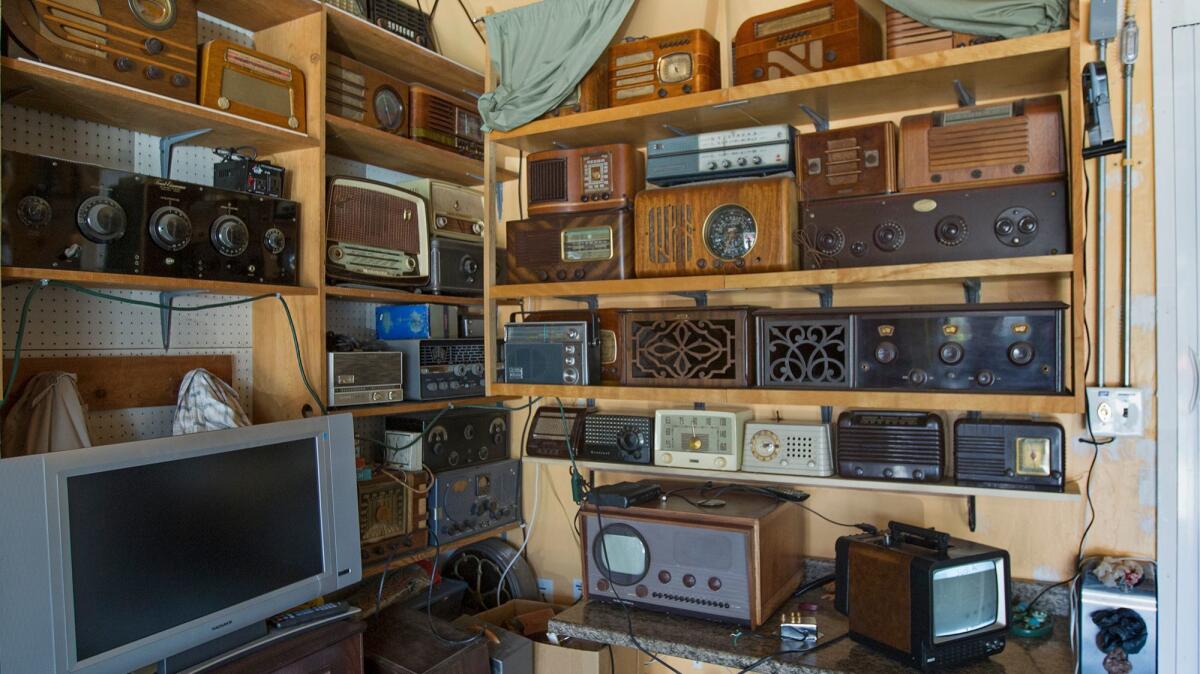 Vintage radios fill a corner in John Eng's garage at his home in La Palma.
