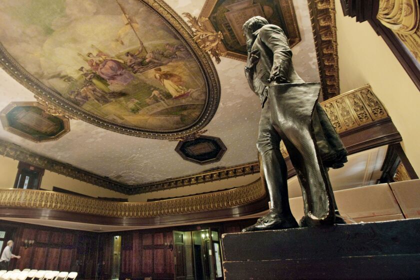 In this July 14, 2010, file photo, a statue of Thomas Jefferson, right, stands in New York's City Hall Council Chamber