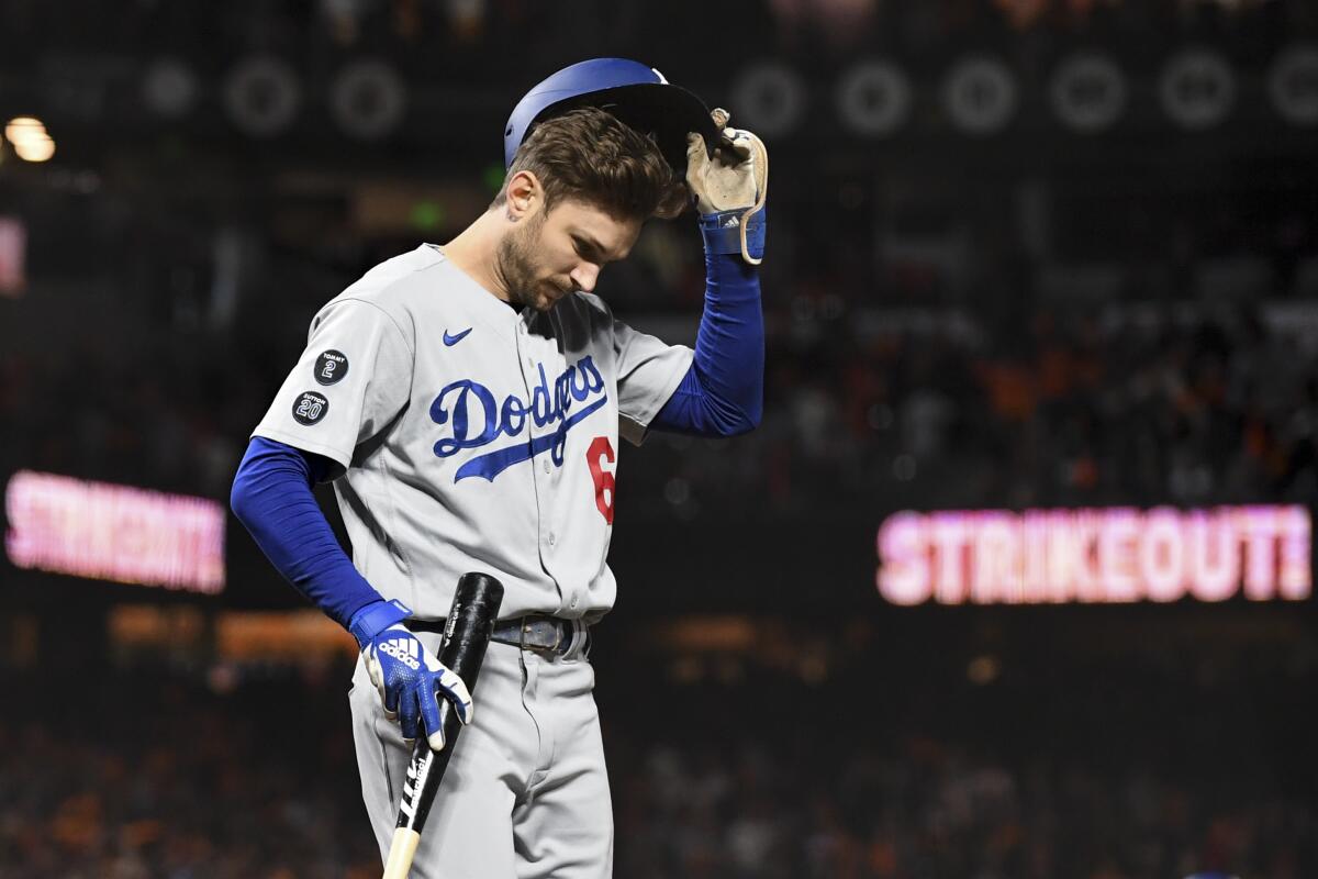 Dodgers second baseman Trea Turner walks off the field after striking out to end the top of the sixth inning.
