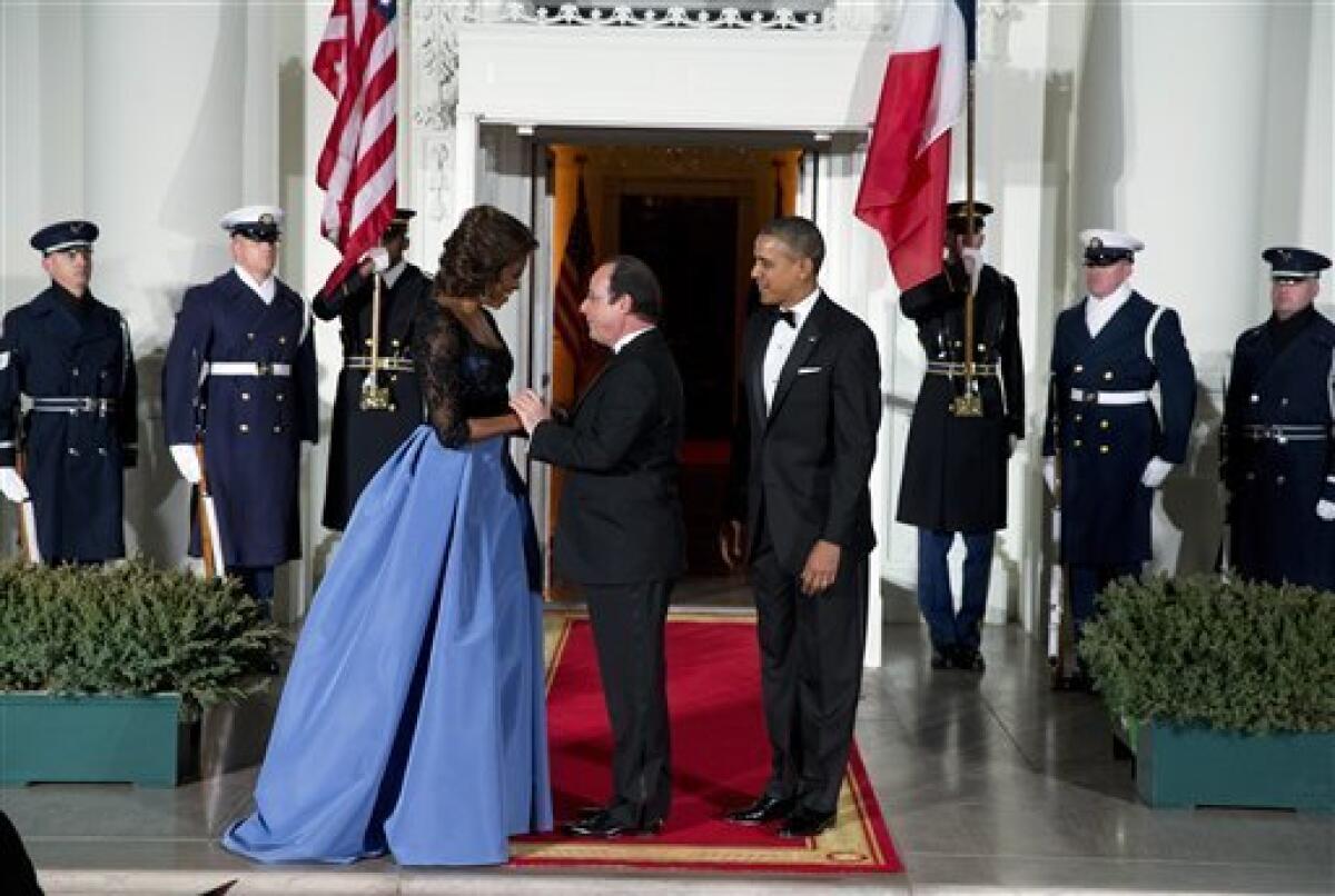 President and First Lady Michelle Obama welcome French President Francois Hollande for a state dinner at the North Portico of the White House.