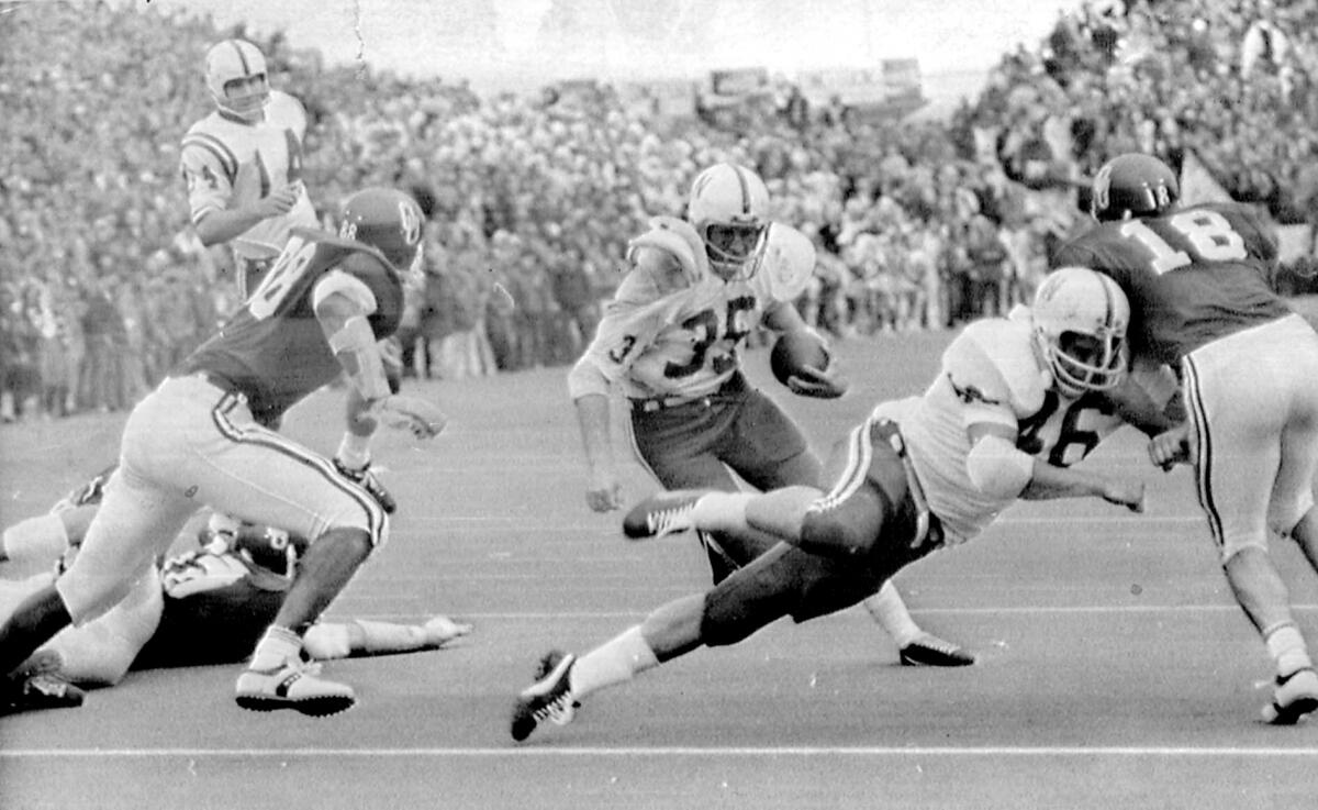 FILE - In this Nov. 25, 1971, file photo, Nebraska's Jeff Kinney (35) gets a block from fullback Maury Damkroger (46) as he scores against Oklahoma from the two-yard line with 1:38 left in a college football game in Norman, Okla., on Thanksgiving Day. The game on Thanksgiving 50 years ago is back in the spotlight as Nebraska and Oklahoma renew their rivalry on Saturday, Sept. 18, 2021. (Tulsa World via AP, File)