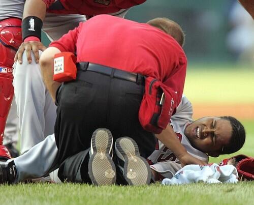 Los Angeles Angels pitcher Ervin Santana is attended to by trainers after being hit in the knee with a line drive by Cleveland Indians' Jason Michaels in the first inning.