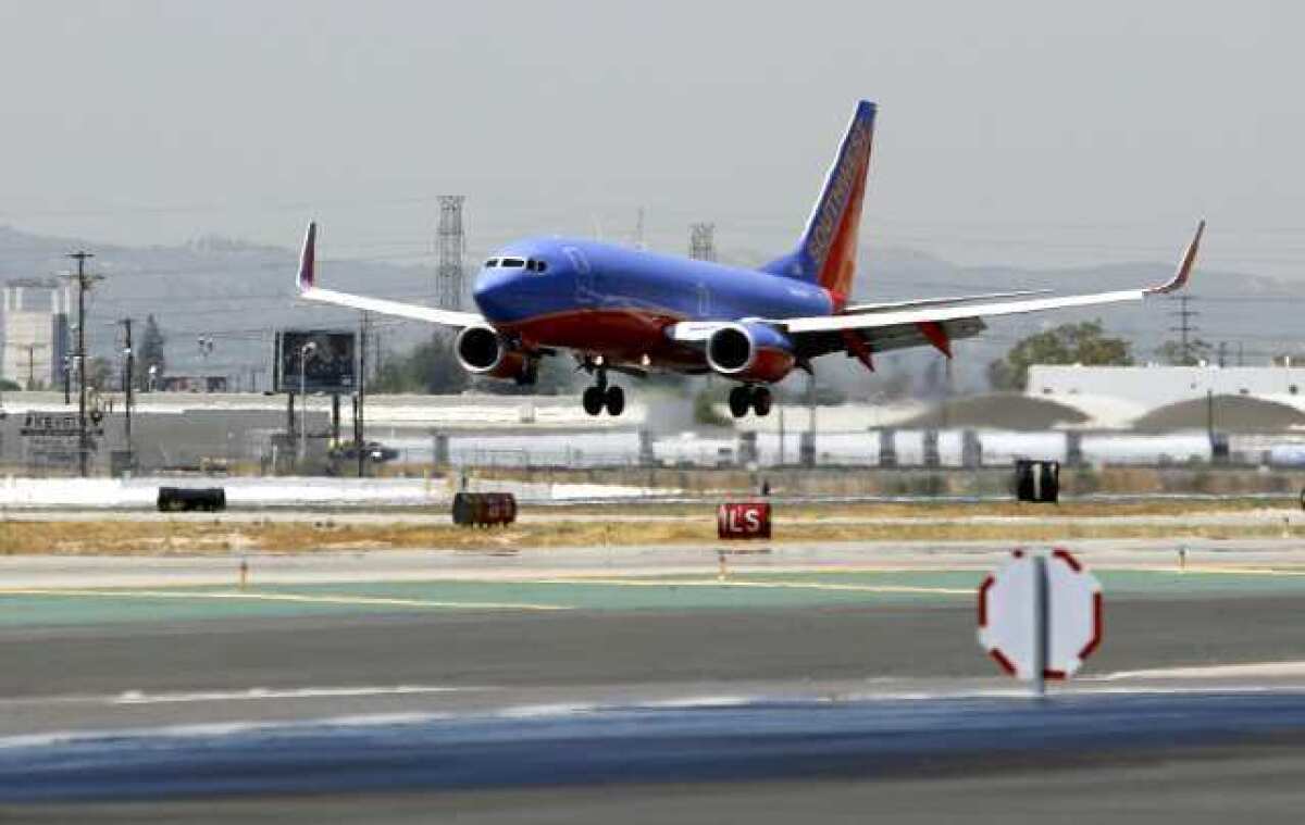 A Southwest Airlines plane lands at the Bob Hope Airport on Thursday, July 19, 2012.