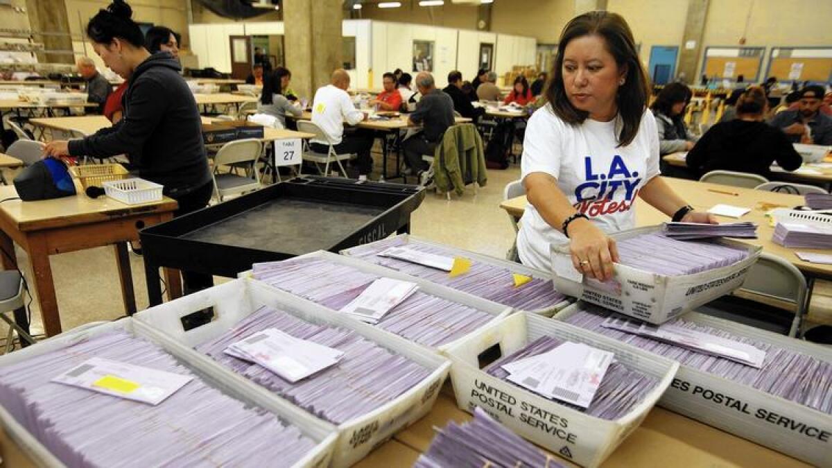 L.A. officials sort uncounted ballots from the Los Angeles primary election in 2015.