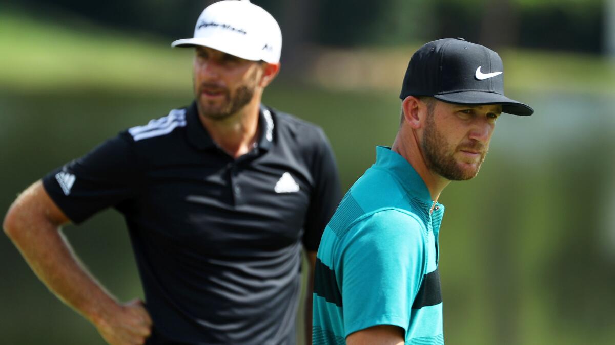 Kevin Chappell (foreground) prepares to putt as Dustin Johnson waits his turn at the 15th green Saturday during the third round of the Tour Championship.