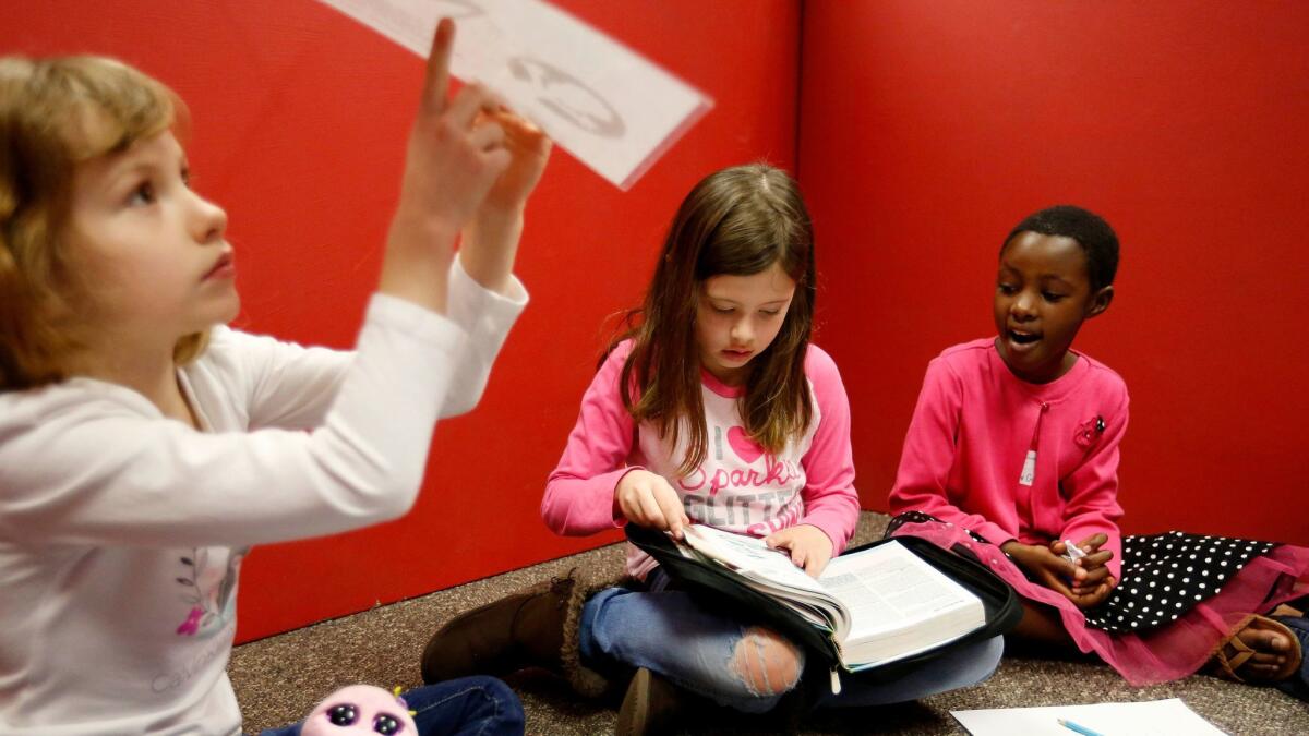 Grace Uwamahoro, right, of Rwanda, studies the Bible in a small group at Pantego Bible Church in Fort Worth.